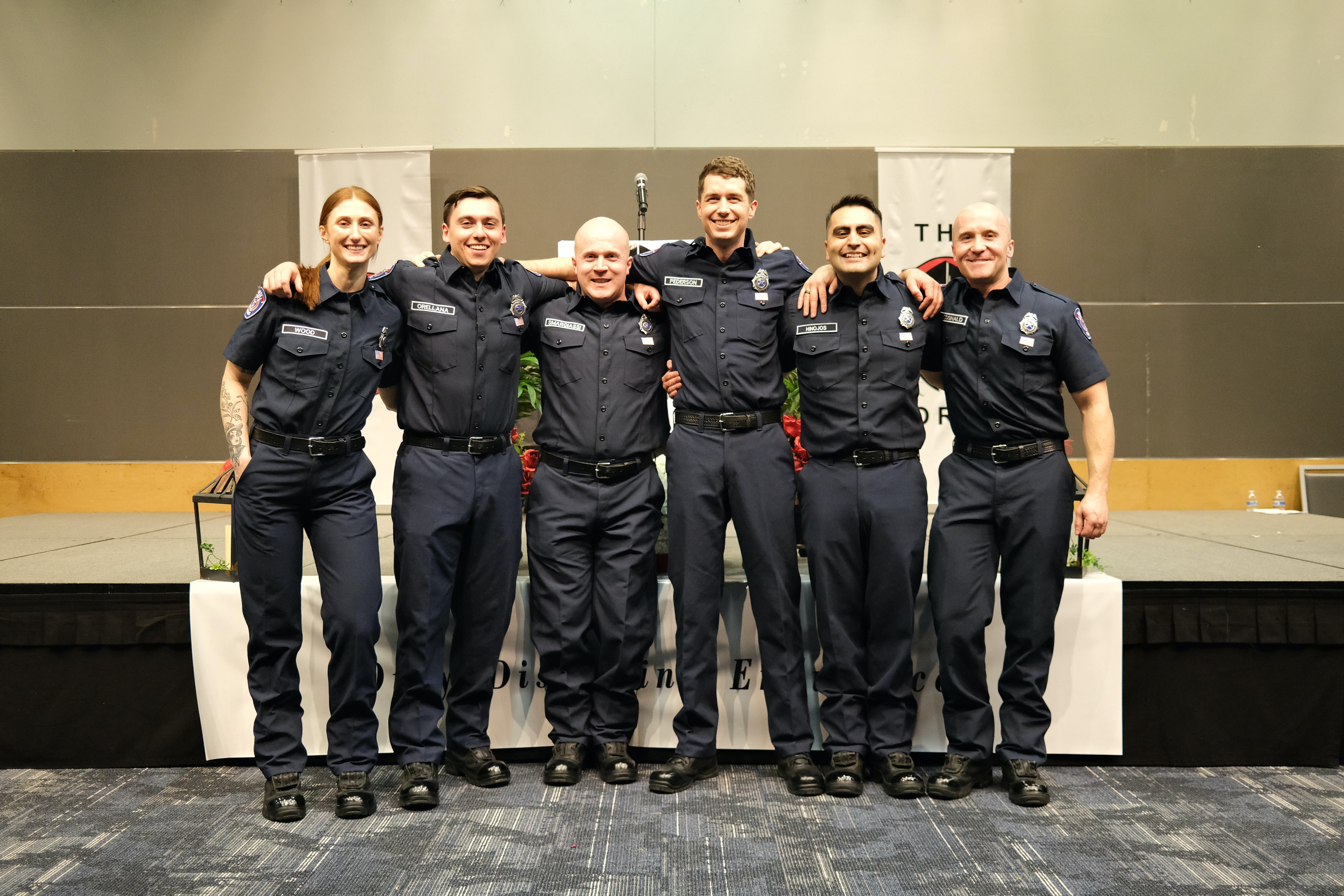 six firefighters standing together in uniform